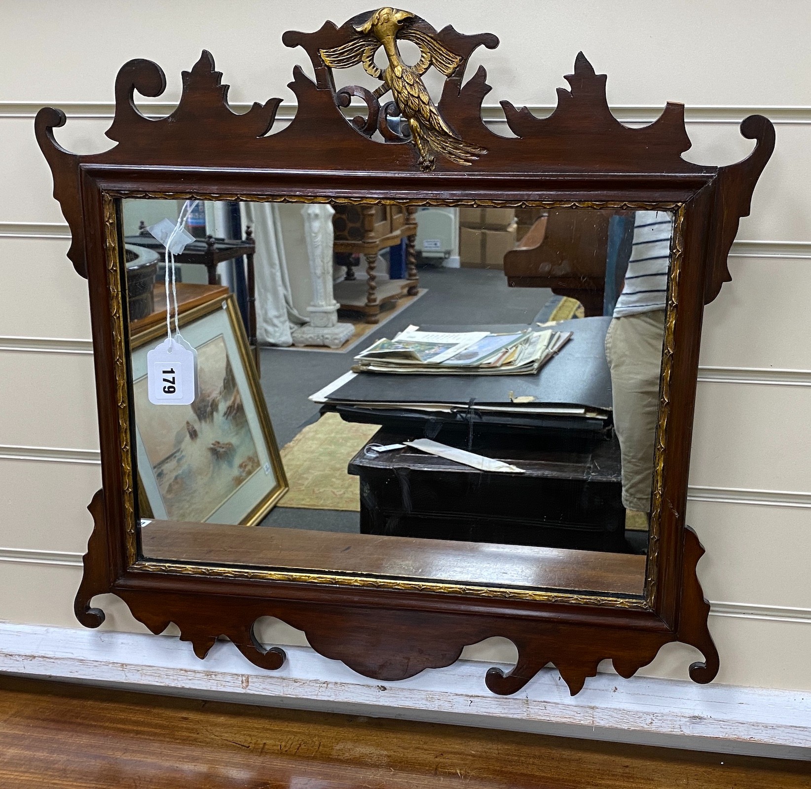 A George III style mahogany and parcel gilt fret cut wall mirror, width 58cm, height 56cm